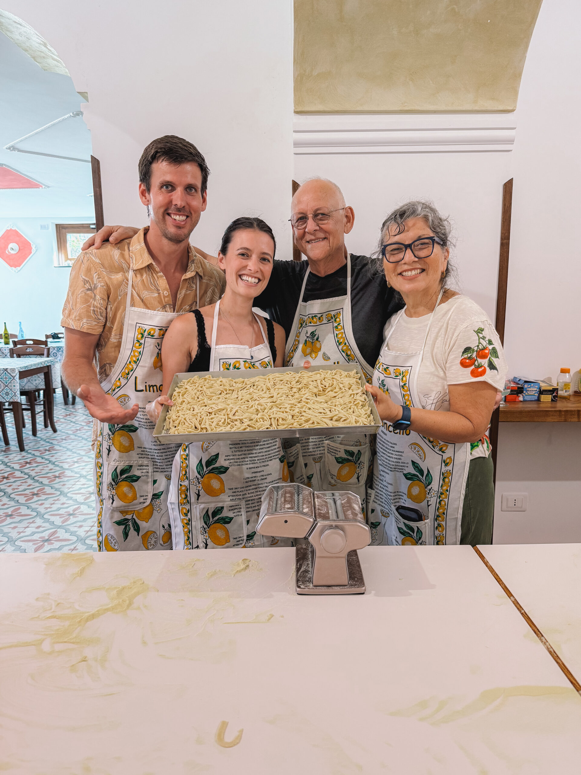 Group cooking class making fresh homemade pasta during an Amalfi Coast cooking experience in Italy.