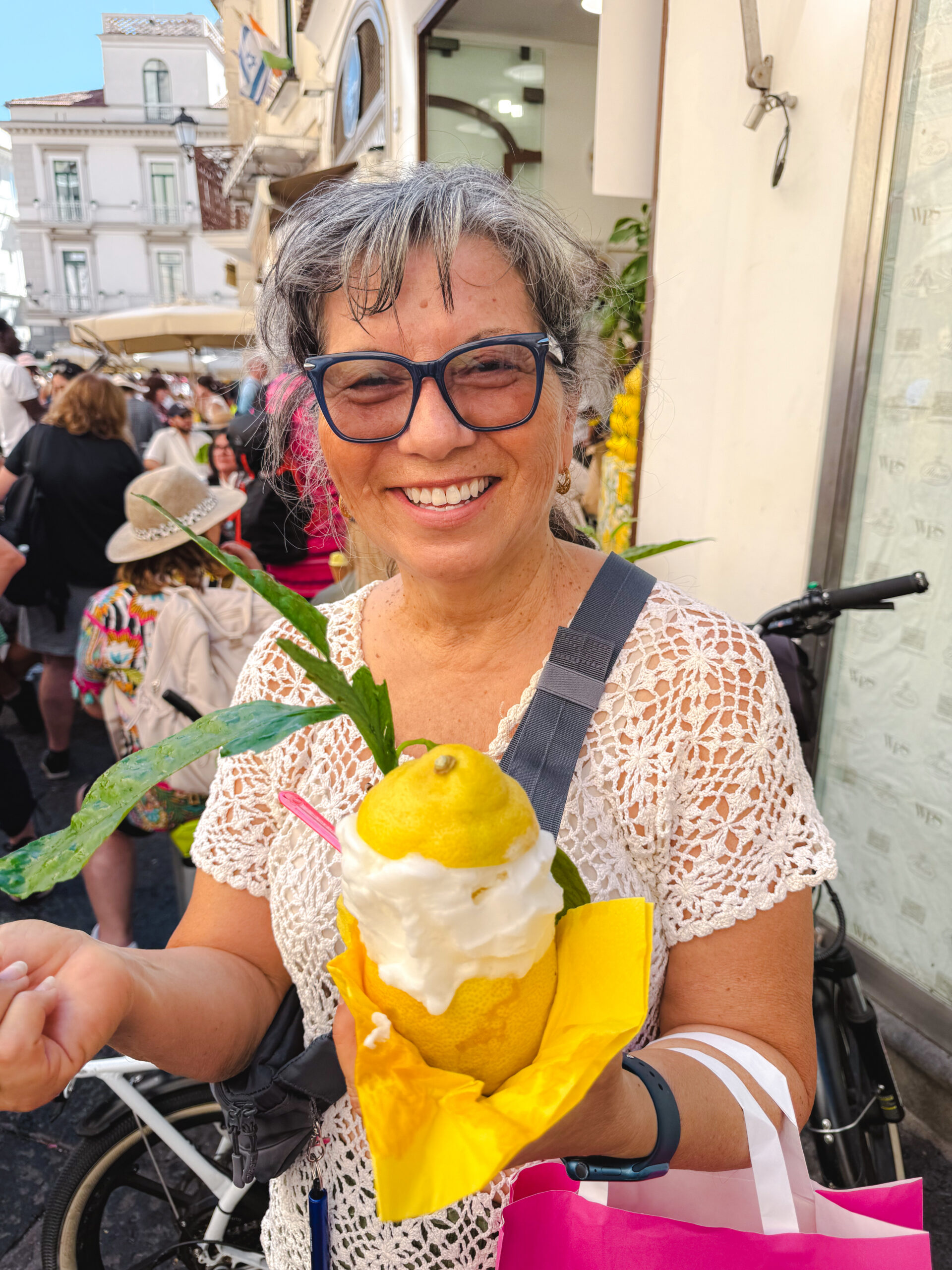 Woman holding a famous lemon dessert on the Amalfi Coast in Italy