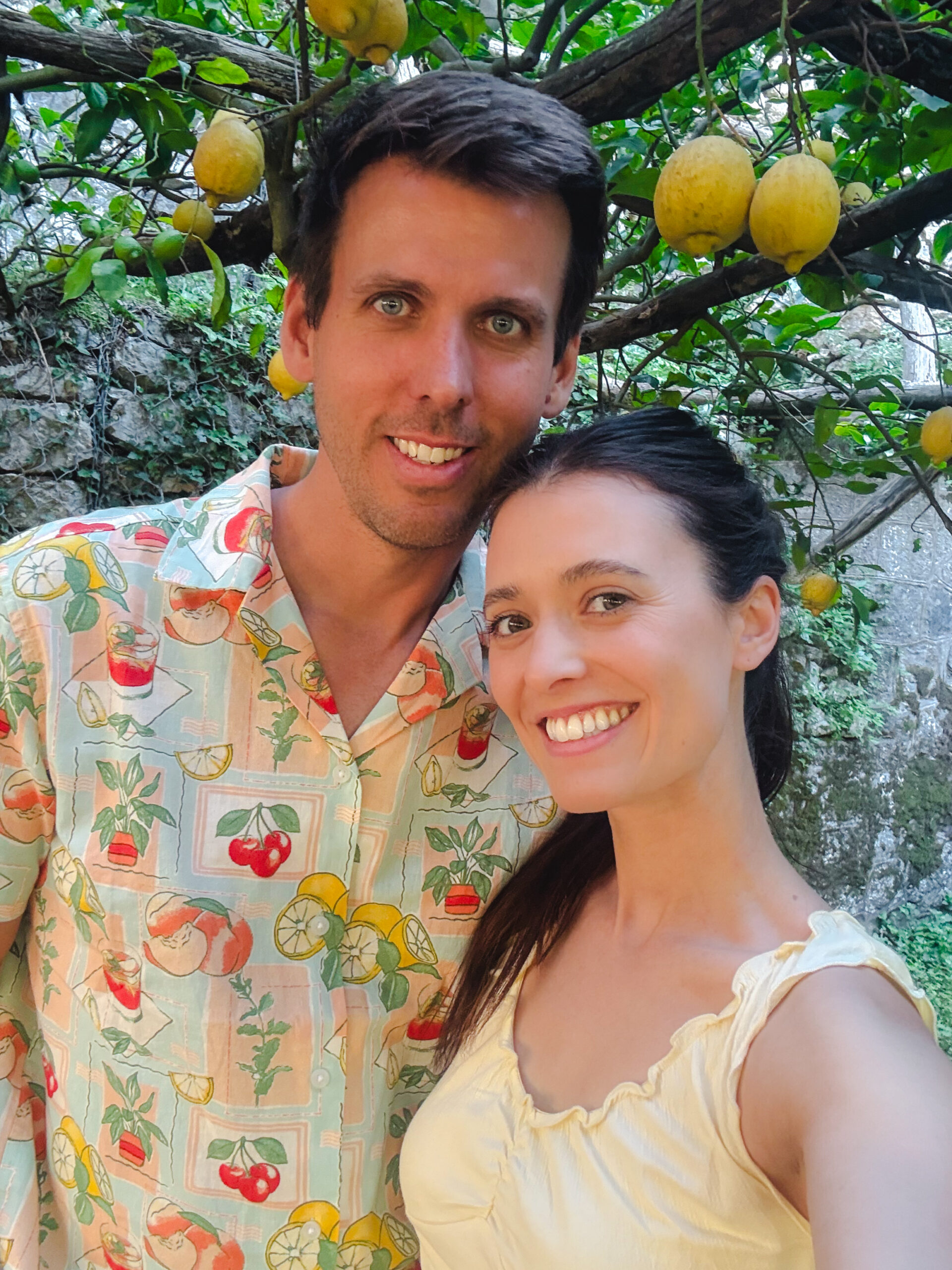 Couple posing under lemon trees during an Amalfi Coast lemon farm tour in Italy.