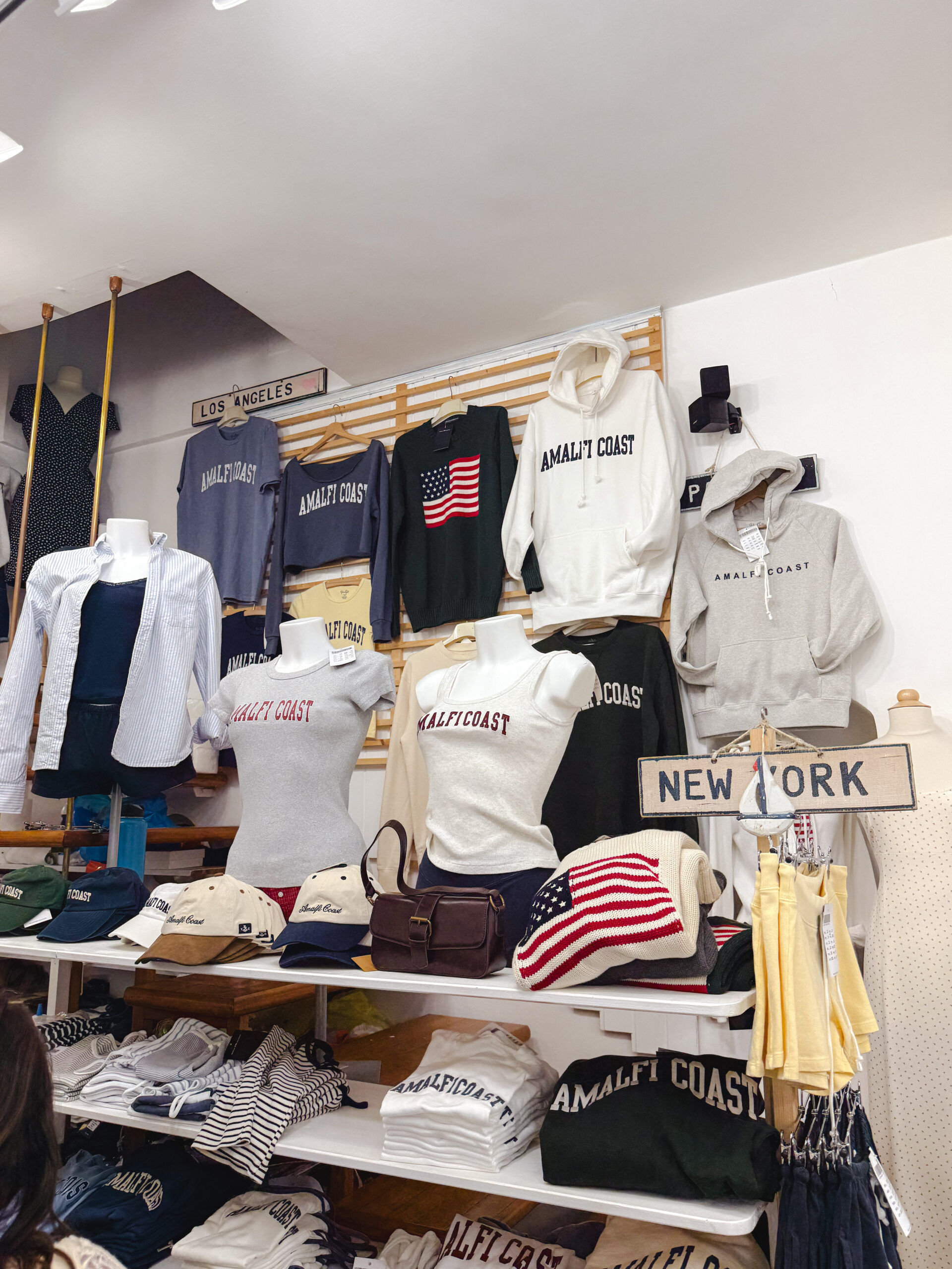 Amalfi Coast souvenir and clothing shop selling sweatshirts, hats, and travel merchandise in Italy.