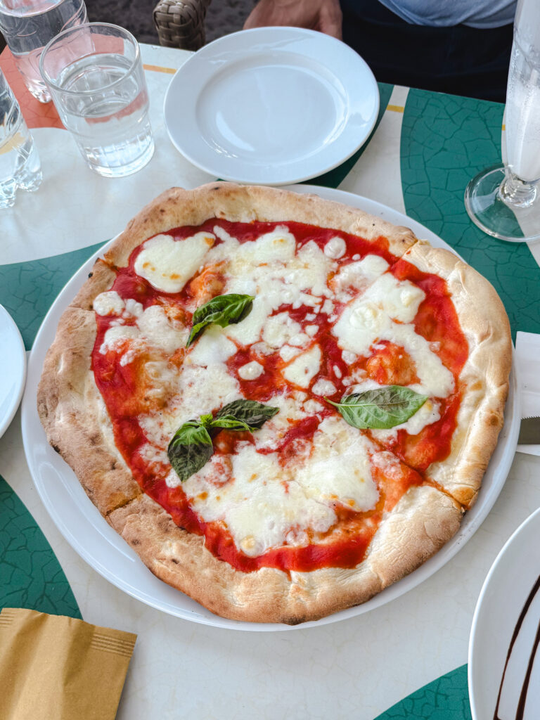Classic margherita pizza with fresh mozzarella and basil at Savoia restaurant in Amalfi, Italy.